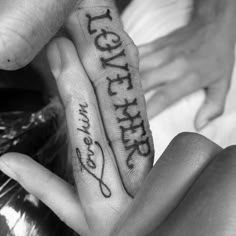 two people holding hands with writing on them