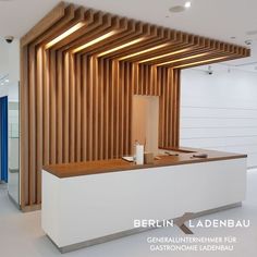 an office with wooden slats on the wall