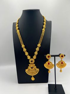 Embrace regal elegance with our exquisite 24K gold-plated Rani Haar set, a true masterpiece designed for the modern queen. This luxurious jewelry set, inspired by traditional royal designs, is perfect for weddings, special occasions, or adding a touch of grandeur to your collection. Care Instructions: To maintain the pristine condition of your Rani Haar set, avoid direct contact with water, perfumes, and harsh chemicals. Store in a dry, cool place when not in use. Luxury Gold Plated Jewelry For Puja, Gold Filigree Bollywood Jewelry, Gold Bollywood Style Filigree Jewelry, Gold-plated Temple Necklace With Elegant Design, Temple Jewelry Sets With Intricate Design In Gold Plated, Gold Plated Meenakari Jewelry Sets, Yellow Gold Bollywood Bridal Necklace, Ceremonial 22k Gold Jewelry Sets For Festivals, Bollywood Style 22k Yellow Gold Bridal Necklace