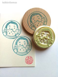 two rubber stamps with an image of a man and a monkey on them next to each other