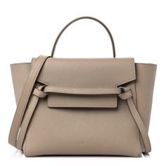 This is an authentic CELINE Grained Calfskin Mini Belt Bag in Light Taupe. This chic tote is crafted of richly textured calfskin leather with a structured and spacious silhouette in beige. The bag features a leather strap top handle, an optional shoulder strap, and a facing flap secured by a strap and brass magnet. This opens to a beige suede leather interior. Luxury White Baguette Bag With Main Compartment, Beige Epsom Leather Bag With Gold-tone Hardware, Formal Cream Epsom Leather Bags, Cream Epsom Leather Bag For Everyday Use, High-end Beige Calf Leather Bag, Timeless Beige Epsom Leather Bag, High-end Beige Epsom Leather Bag, Classic Beige Epsom Leather Shoulder Bag, Beige Calf Leather Bag With Top Carry Handle