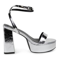 Step into the spotlight with Isabella, the silver platform sandal that will elevate any outfit! Featuring a removable crystal bow, you can play up the glamour or keep it simple. Heel Height 5" Platform height 1.5" Material Vegan Leather Modern Silver Sandals With 4-inch Heel, Glamorous Chunky Platform Sandals, Silver Sandals With Padded Heel For Night Out, Elegant Chunky Platform Sandals For Party, Silver Platform Heels With Ankle Strap, Luxury Chunky Platform Sandals For Party, Glamorous Chunky Platform Sandals For Night Out, Spring Gala Platform Sandals, Silver Chunky Platform Heels For Evening