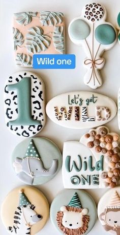 a bunch of cookies that are on a white surface with the words wild one written in it