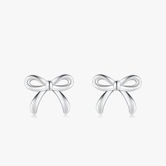 Discover the epitome of sweetness and style with our Charming Bowknot Hypoallergenic Stud Earrings. Perfectly capturing the essence of simplicity and elegance, these cute stud earrings feature an exquisite bowknot design that adds a touch of whimsy to any look. Crafted with care, these earrings are made from hypoallergenic materials, ensuring they're gentle on even the most sensitive ears. Each bowknot is meticulously designed to showcase a blend of classic charm and modern sophistication, making these earrings a versatile addition to any jewelry collection. Whether you're dressing up for a special occasion or adding a playful touch to your everyday ensemble, these bowknot studs are sure to become your go-to accessory. Not only do these earrings boast a timeless design, but they also prior Chic Bow Earrings For Anniversary, Silver Butterfly Knot Earrings As Gift, Silver Butterfly Knot Earrings For Gift, White Gold Bow Earrings For Gift, Chic Silver Earrings With Decorative Bow, Classic Bow Earrings For Party, Elegant White Gold Earrings With Bow, Classic Bow Earrings For Anniversary, Bow Earrings For Gift