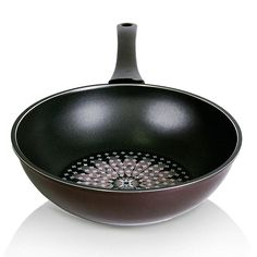 a black frying pan with an ornate design on the bottom and side rims