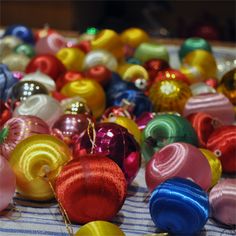 many different colored ornaments are on the table