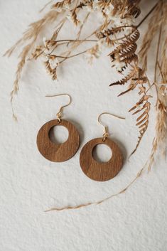 Pair of wooden earrings Round shaped, hoop earrings. They are very light and pleasant to wear, approximately 1 gram per earring! Made of poplar wood, stained walnut color with natural dye (walnut stain) with mainly recycled wood, in order to preserve our planet. We work with wood and this material is subject to variation in terms of color and grain. The hook is available in stainless steel, hypoallergenic. Gold, silver, or bronze color. Size : Small: approximately 3.5 cm Medium: approximately 4. Shaped Hoop Earrings, Mother Of Pearl Jewelry, Wooden Hoop, Boho Geometric, Earrings Round, Le Crochet, Walnut Stain, Wooden Earrings, Poplar Wood