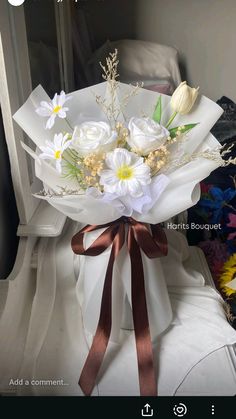 a bouquet of flowers sitting on top of a white box