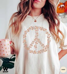 "Hippie Peace Sign Shirt, Boho Peace Oversized Tee, Floral Peace Symbol, Wildflowers T-Shirt, Peace Symbol Shirt, Graphic Tees For Women Our shirts are unisex sizing and they are made with the highest quality materials and are super soft and cozy! This style is UNISEX Garment-Dyed, RELAXED FIT, Comfort Colors T-shirt. If you'd like an oversized look, we suggest size up 1-2 sizes from your normal size! 👉FABRICATION * 6.1 oz., 100% ringspun cotton * Medium fabric * The soft-washed, garment-dyed f Peace Sign Clothes, Peace Sign Shirt, Peace Sign Shirts, Graphic Tees For Women, Hippie Peace, Selling Clothes, Tees For Women, Oversized Tee, Peace Sign