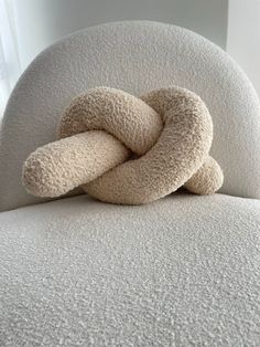 a white chair with a knot on it