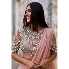 📌Hey! Please message us if you have any questions. We'll definitely assist you. A blouse with intricate handwork and beads can be a stunning addition to your wardrobe, especially if you're looking for something inspired by Bollywood Indian actress Mrunal Thakur's style. Here's a description that captures the essence of this fashion statement: The blouse is crafted with detailed handwork, featuring a combination of beads, sequins, and intricate embroidery that creates a unique and eye-catching pattern. The design is a harmonious blend of traditional and contemporary elements, with vibrant colors and a rich texture that draws attention. The blouse is tailored to fit elegantly, with intricate detailing along the neckline and sleeves, and the use of beads adds a touch of glamour and sophistic Bohemian Wedding Blouse With Mirror Work, Festive Embellished Tops For Wedding, Festive Embellished Wedding Tops, Bohemian Embellished Wedding Tops, Bohemian Embellished Tops For Wedding, Blouse With Beads, Handwork Blouse, Blouse Lehenga, Mrunal Thakur