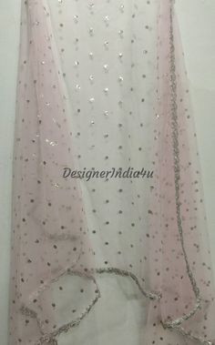 This is a Dupatta made on orders. It is made using dyeable net fabric with silver sequine embroidery all over. We make it colored as shown in the picture. Then we stitch a beautiful silver lace to all sides of it. Dupatta is having a length of 100 inches and width of around 40 inches. I don't keep it readymade I only make it exclusively for my customers. Can be fully customised. Pink Semi-stitched Net Lehenga, Pink Resham Embroidery Anarkali Set, Pink Net Lehenga With Resham Embroidery, Festive Pink Sharara With Sheer Dupatta, Pink Festive Sharara With Sheer Dupatta, Unstitched Pink Sharara For Celebration, Pink Net Sharara With Traditional Drape, Traditional Pink Net Lehenga, Pink Net Sets With Resham Embroidery