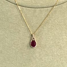 Adorn yourself in timeless elegance with this exquisite ruby pendant encircled by sparkling diamond accents. Crafted with solid 14K yellow, white or rose gold, this shimmering piece will capture the light and draw the eye. An undeniable symbol of beauty, this pendant will make a surefire statement!