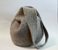 a gray bag sitting on top of a white table