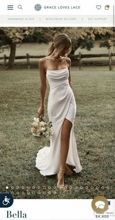 a woman in a white dress holding a bouquet and walking through the grass with her hand on her hip