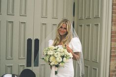 a woman in a wedding dress holding a bouquet