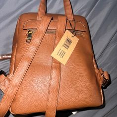 Never Used, Still Has Tags Trendy Brown Backpack With Zipper Pocket, Casual Leather Backpack For On-the-go, Trendy Softback Backpack With Adjustable Strap, Trendy Backpack With Adjustable Strap, Trendy Brown Leather Backpack For On-the-go, Trendy Leather Bags With Adjustable Straps, Casual Leather Satchel Backpack With Adjustable Straps, Casual Leather Backpack With Adjustable Strap For On-the-go, Casual Leather Softback Backpack For On-the-go