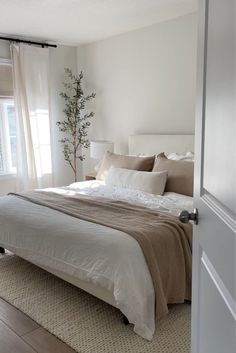 a bed sitting in a bedroom next to a window