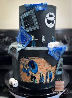 a black cake with blue decorations and dice