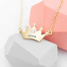 For a fabulous gift that'd be perfect for a princess of any age, she's bound to love our super-cute personalised kids princess crown necklace. She's bound to love and show off her beautiful new necklace to her friends, its elegant craftsmanship and gorgeous design are guaranteed to impress her queendom. This stylish necklace will make a wonderfully sentimental birthday gift for your little princess or a fabulous Christmas present for that future queen in your life.   Each point of your loved one's crown-design necklace is encrusted with a small crystal, with a slightly large crystal placed prominently in a central position on the crown.   Personalise your loved one's necklace with their name for a gift that is as unique as they are. Our dedicated team of artisan creatives will then meticul Crown Pendant, Princess Jewelry, Personalized Jewelry Box, Princess Necklace, Crown Necklace, Fabulous Christmas, New Necklace, Crown Design, Kids Necklace