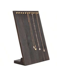 a wooden stand with several necklaces on it