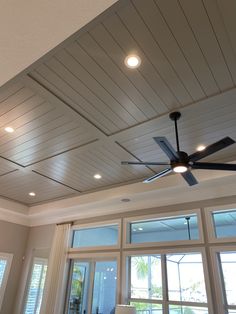 a ceiling fan in the middle of a living room