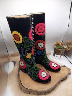 These are genuine leather handembroidered custom made  knee high boots. Made with genuine leather, suzani embroidered velvet, special sole, ykk zipper. There is every size is available, 6 us to 10.5 us, 36 eu to 42 eu. There is colorful floral pattern on black leather velvet. These boots are light and very confortable. Water proof, wearable under the rain, snow, sunshine. İf you need wider calf please send us your calf circle measurments. These are hand made boots.  İf you would like to get high Bohemian Knee-high Boots For Festivals, Embroidered Leather Knee-high Boots, Traditional Black Boots With Leather Sole, Embroidered Snip Toe Boots For Festival, Handmade Bohemian Leather Boots, Embroidered Winter Festival Boots, Winter Festival Embroidered Boots, Bohemian Leather Boots With Floral Embroidery, Winter Leather Boots With Embroidery