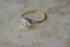 a diamond ring sitting on top of a marble surface