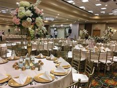 a banquet hall with tables and chairs set for an event