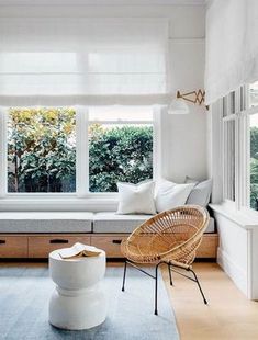 a living room with white walls and windows