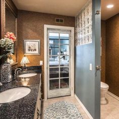 a bathroom with blue walls and white fixtures