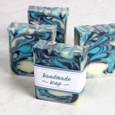 three soap bars sitting on top of each other in front of a white countertop