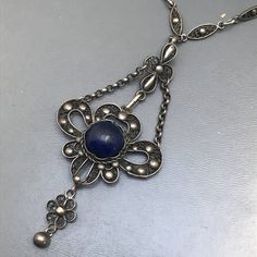 Fine Vintage Art nouveau / Art deco silver filigree pendant necklace ~ Pendant has a central bezel set blue lapis stone set on an filigree base ~ which is attched to a fine filigree chain . Clasp is Marked DRGM / Deutsches Reich Geschmacksmuster for German patent mark . Necklace is acid tested for silver Measurements : Necklace is 20 inches in length x 3/8 inches max chain width .Pendant adds 3 inches in total drop length x 1 1/4 inches max width Weighs 16 grams on my weighing scale . Condition: