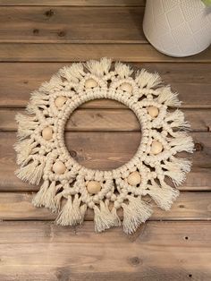 a white doily wreath sitting on top of a wooden floor