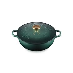 a green casserole with a gold knob on the top and handles, sitting in front of a white background