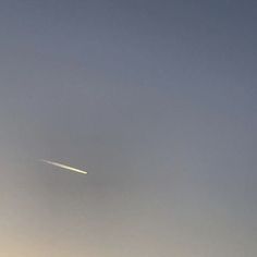 an airplane is flying in the sky on a foggy day