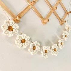 crocheted flowers are hanging on the wall