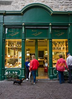 people are standing in front of a store