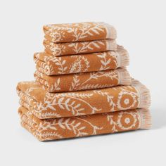 six orange towels stacked on top of each other