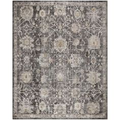 a gray and white rug with flowers on it