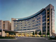 a large building with many windows and lights on it's sides at night time