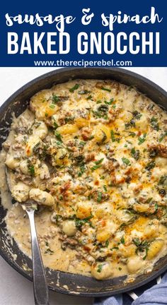 sausage and spinach baked gnocchini in a skillet with a spoon