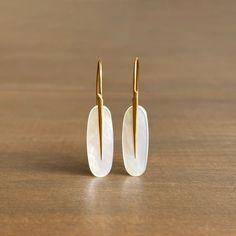 The glistening luster of these mother of pearl slices are showcased fabulously in Rachel Atherley's signature feather design. 

18k yellow gold 
Mother of pearl 8mm x 22mm (5/16" x 7/8")
Earrings hang 1 7/16" from the ear 
Each earring weighs 1.5g Pearl Earrings Designs, Cabochon Earrings, Mother Of Pearl Jewelry, Mother Of Pearl Earrings, Newport Ri, Feather Jewelry, Gold Pearl Earrings, Cabochon Jewelry, Feather Design