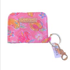 a pink purse with a keychain attached to it