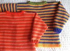 three knitted sweaters laying on top of each other