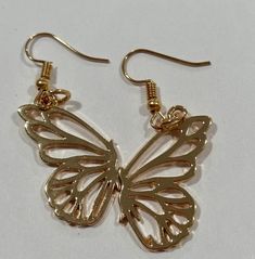 Elevate your style with these Golden Flutter Earrings. Crafted with delicate gold-plated butterfly wings, these earrings capture the elegance and grace of nature. Perfect for adding a touch of whimsy and sophistication to any outfit, they feature a lightweight design for all-day comfort. Ideal for special occasions or as a stunning everyday accessory. Let your beauty take flight with these enchanting earrings. Butterfly Wing Earrings, Butterfly Wing, Wing Earrings, Everyday Accessories, Butterfly Wings, Jewelry Earrings Dangle, Special Occasion, Dangle Earrings, Jewelry Earrings