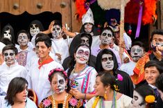 a group of people with painted faces posing for a photo