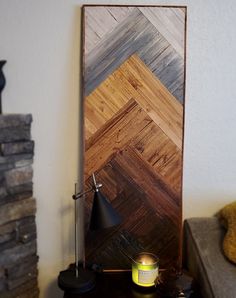 a table with a lamp and some books on it next to a wall made out of wood planks