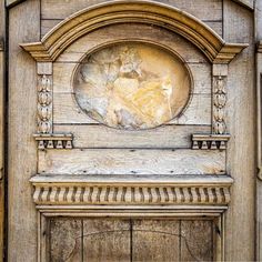 an old wooden door with a carving on the front and side panel, in wood