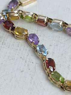 Oval Multi-stone Gemstones, Dazzling Oval Multi-stone Gemstones, Luxury Oval Multi-stone Tennis Bracelet, Elegant Multicolor Gemstones For Formal Occasions, Elegant Multicolor Tennis Bracelet For Formal Occasions, Elegant Formal Multicolor Tennis Bracelet, Oval Multi-stone Tennis Bracelet In Fine Jewelry Style, Oval Multicolor Jewelry For Formal Occasions, Fine Jewelry Multicolor Wedding Bracelet